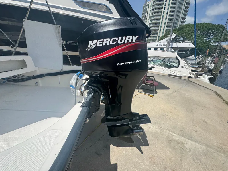 Slide: The Image of 2004 Boston Whaler 150 Sport with Mercury FourStroke EFI outboard at marina. - 6