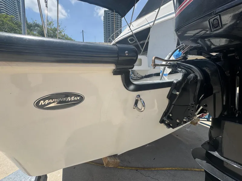 Slide: The Image of 2004 Boston Whaler 150 Sport boat stern with MarineMax logo and outboard motor. - 7