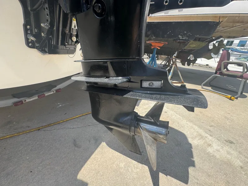 Slide: The Image of Outboard motor of a 2004 Boston Whaler 150 Sport boat on a trailer. - 9