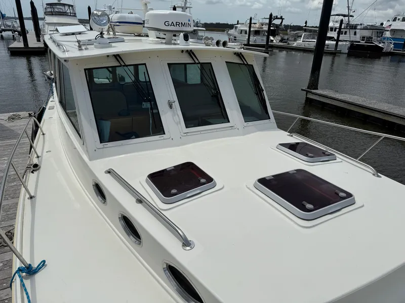 Slide: The Image of 2006 Mast & Mallet Thomas Point 40 boat docked at marina, featuring Garmin equipment. - 12