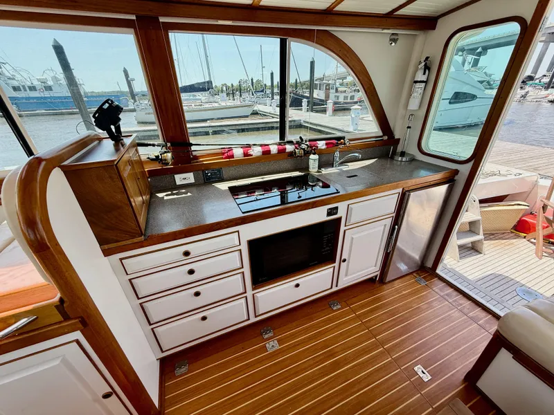Slide: The Image of Elegant 2006 Mast & Mallet Thomas Point 40 yacht interior with modern kitchen and scenic marina view. - 19