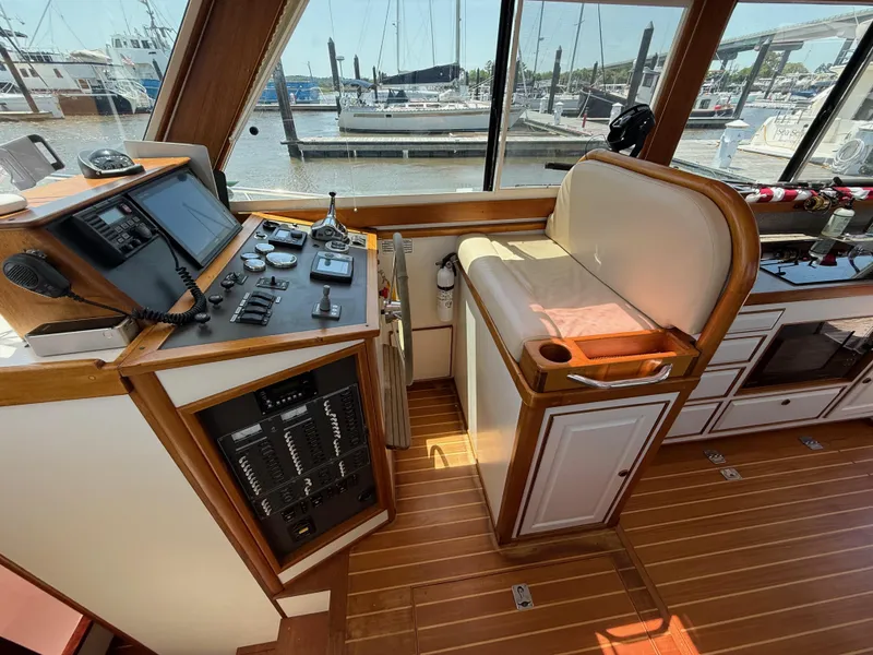 Slide: The Image of Interior helm of 2006 Mast & Mallet Thomas Point 40 boat, featuring control panel and seating. - 23