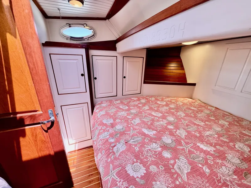 Slide: The Image of Cozy cabin interior of 2006 Mast & Mallet Thomas Point 40 with floral bedding. - 33