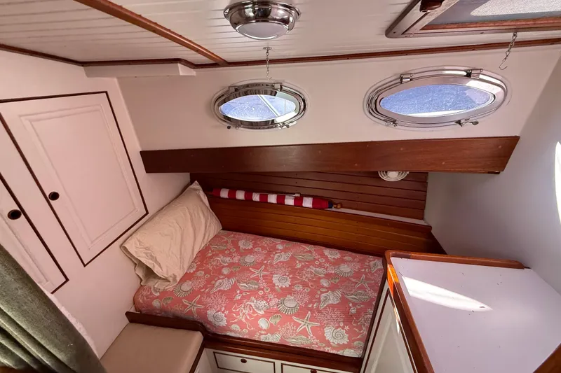 Slide: The Image of Cozy cabin interior of 2006 Mast & Mallet Thomas Point 40 boat with portholes and bed. - 34