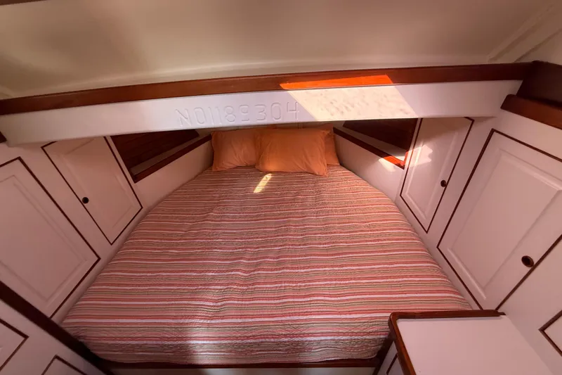 Slide: The Image of Cozy cabin interior of 2006 Mast & Mallet Thomas Point 40 with striped bedding. - 38