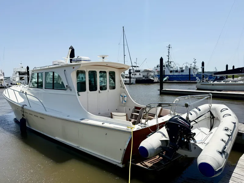 Slide: The Image of 2006 Mast & Mallet Thomas Point 40 boat docked with inflatable dinghy attached. - 4
