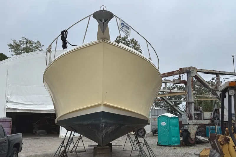 Slide: The Image of 2006 Mast & Mallet Thomas Point 40 boat on dry dock, surrounded by equipment. - 7
