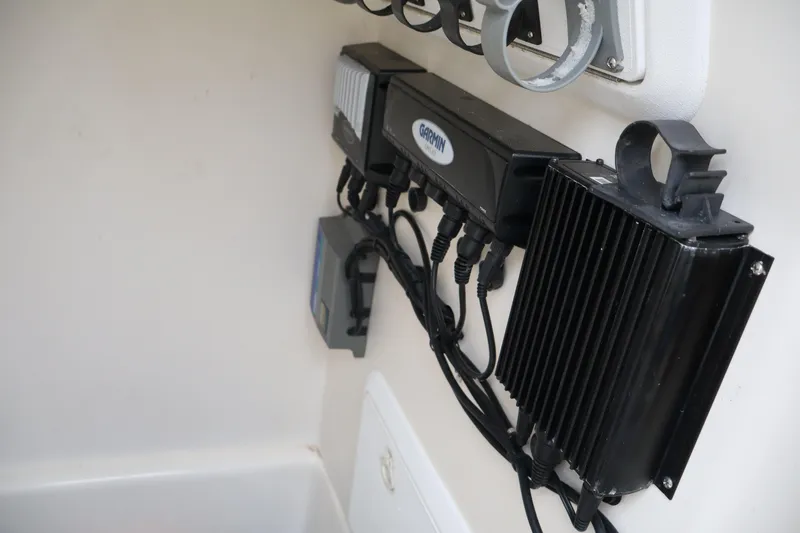 Slide: The Image of Electrical components inside a 2004 Edgewater 225CC boat, featuring Garmin equipment. - 14