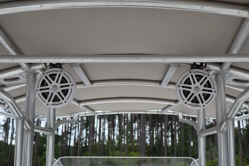 Slide: The Image of T-top speakers on a 2004 Edgewater 225CC boat with forest background. - 15