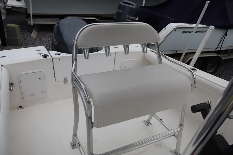 Slide: The Image of 2004 Edgewater 225CC boat with white seating and metal frame. - 16