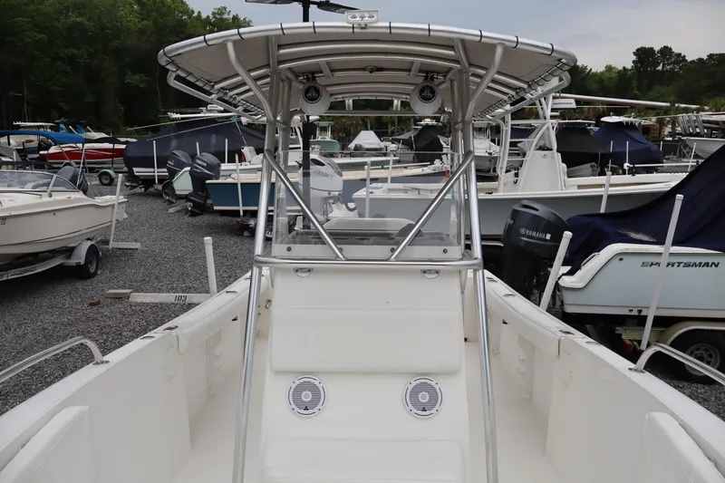 Slide: The Image of 2004 Edgewater 225CC boat with T-top, docked among other boats. - 18