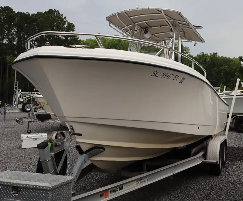 Slide: The Image of 2004 Edgewater 225CC boat on trailer, parked outdoors. - 3