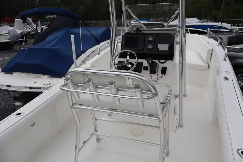 Slide: The Image of 2004 Edgewater 225CC boat interior with steering console and seating. - 6