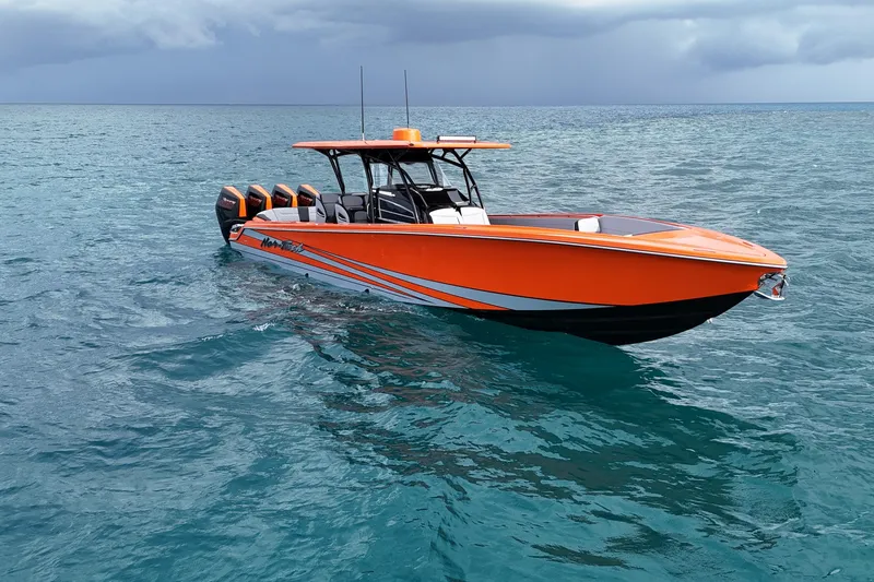 Slide: The Image of 2026 Nor-Tech 390 Sport Center Console boat in vibrant orange on open water. - 12