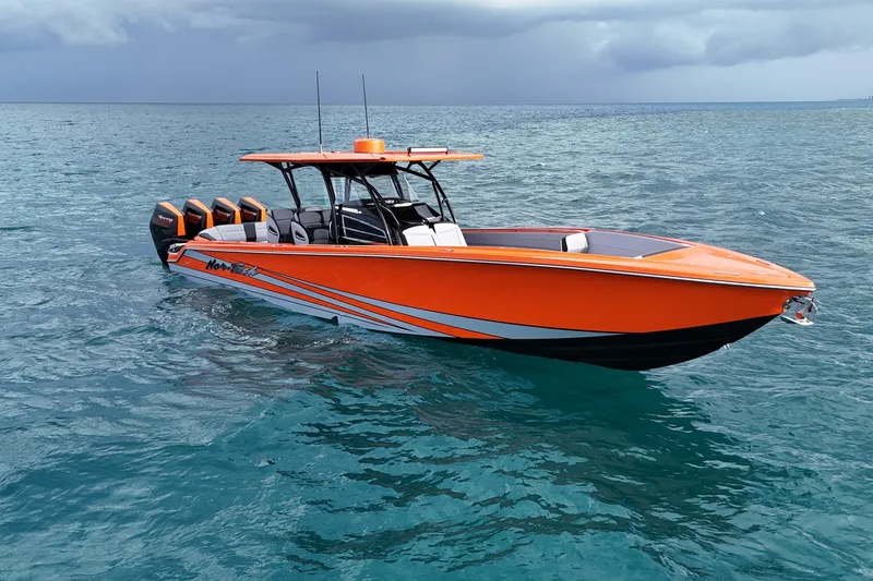 Slide: The Image of 2026 Nor-Tech 390 Sport Center Console boat in vibrant orange on open water. - 13