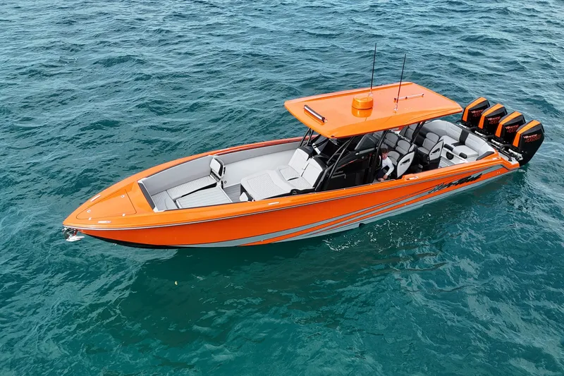 Slide: The Image of 2026 Nor-Tech 390 Sport Center Console boat in vibrant orange on open water. - 17