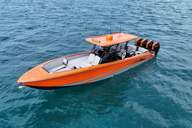 Slide: The Image of 2026 Nor-Tech 390 Sport Center Console boat in vibrant orange on open water. - 19
