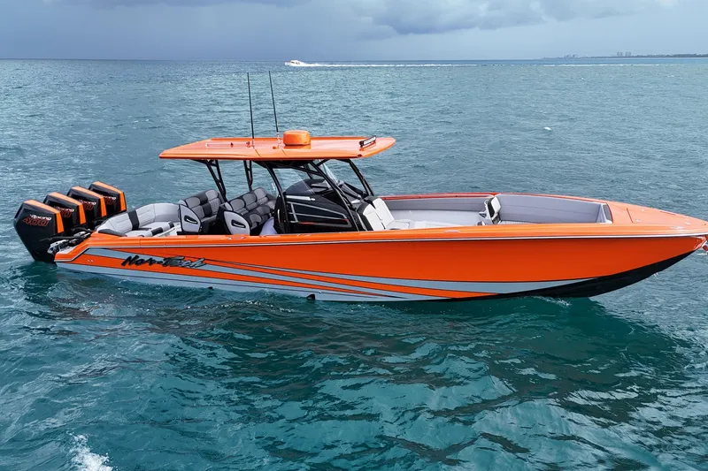 Slide: The Image of 2026 Nor-Tech 390 Sport Center Console boat in vibrant orange on open water. - 22