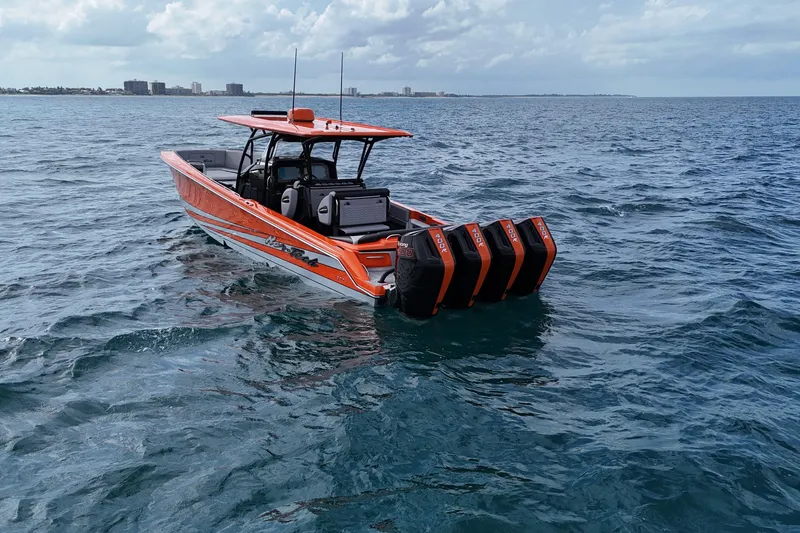 Slide: The Image of 2026 Nor-Tech 390 Sport Center Console boat on open water, featuring four powerful engines. - 9