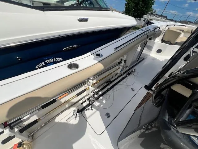 Slide: The Image of 2020 Tidewater 272 CC Adventure boat with fishing rods on deck, sunny day. - 13