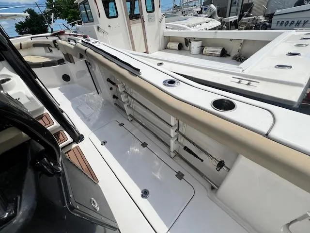 Slide: The Image of 2020 Tidewater 272 CC Adventure boat interior with storage compartments and seating. - 14