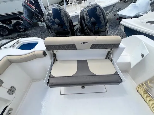 Slide: The Image of 2020 Tidewater 272 CC Adventure boat with dual engines and cushioned seating. - 2