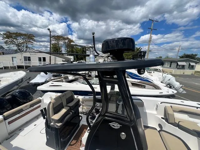 Slide: The Image of 2020 Tidewater 272 CC Adventure boat with seating, under a partly cloudy sky. - 5