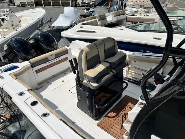 Slide: The Image of 2020 Tidewater 272 CC Adventure boat interior with dual seats and twin engines. - 6
