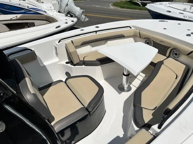 Slide: The Image of 2020 Tidewater 272 CC Adventure boat with spacious seating and table setup. - 7