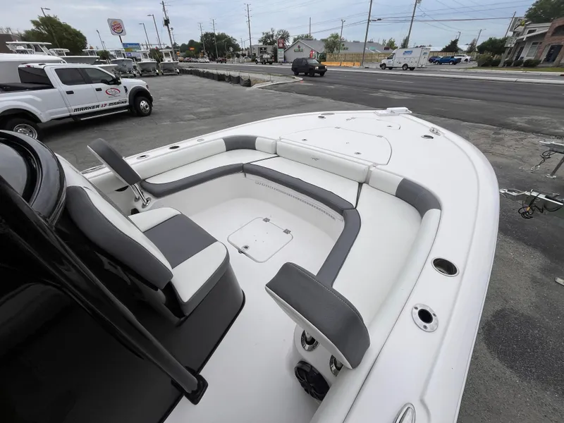 Slide: The Image of 2021 Tidewater 2500 Carolina Bay boat with spacious seating, parked in a lot. - 10