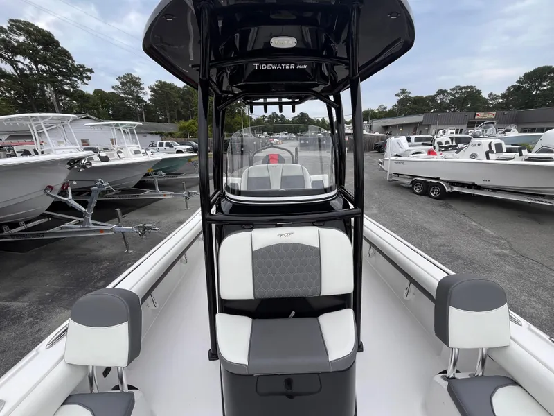 Slide: The Image of 2021 Tidewater 2500 Carolina Bay boat with sleek seating and modern design in a marina setting. - 11