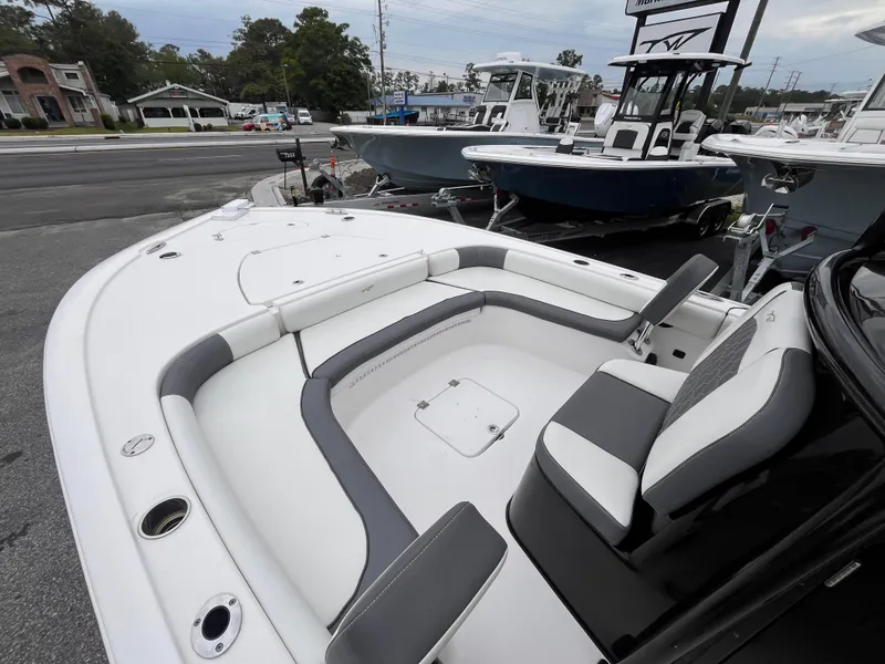 Slide: The Image of 2021 Tidewater 2500 Carolina Bay boat with spacious seating and sleek design, docked outdoors. - 12