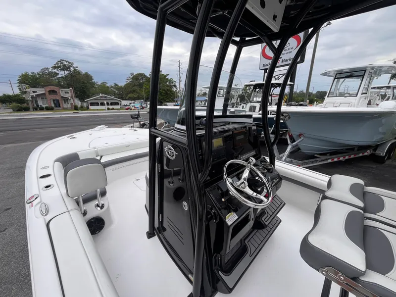 Slide: The Image of 2021 Tidewater 2500 Carolina Bay boat interior with steering console and seating. - 13