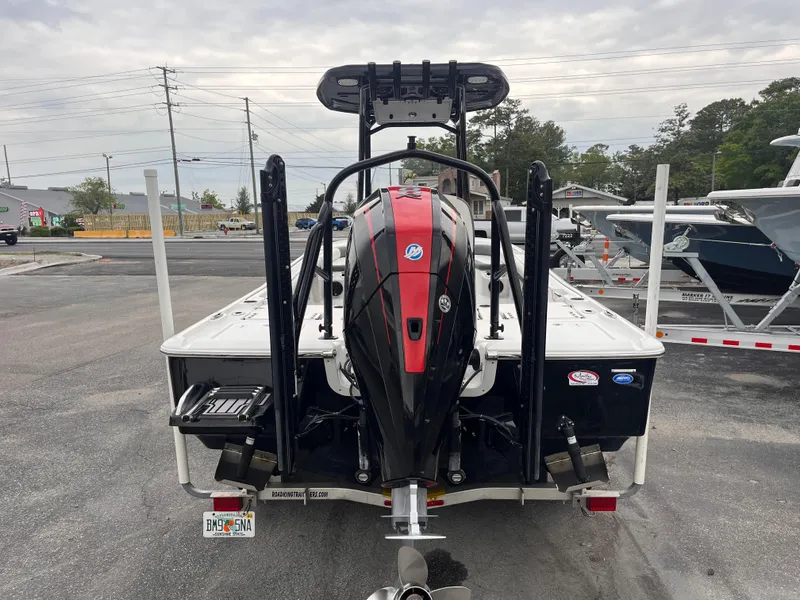 Slide: The Image of 2021 Tidewater 2500 Carolina Bay boat with powerful outboard motor, parked on a trailer. - 3