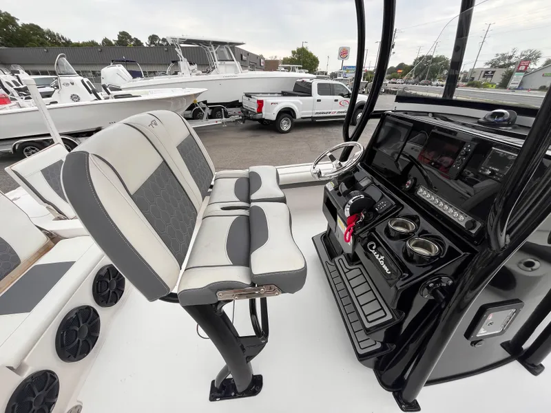 Slide: The Image of 2021 Tidewater 2500 Carolina Bay boat interior with dual seats and modern dashboard. - 7