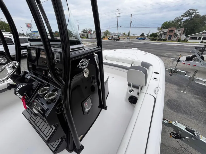 Slide: The Image of 2021 Tidewater 2500 Carolina Bay boat interior with console and seating, parked on a trailer. - 9