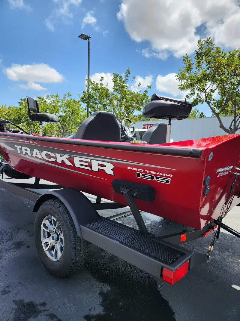 Slide: The Image of 2025 Tracker Pro Team 195 Tournament Edition boat on trailer, parked outdoors. - 2