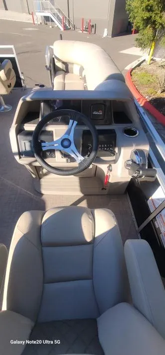 Slide: The Image of 2025 Sun Tracker SportFish 20 DLX boat interior with steering wheel and seating. - 4