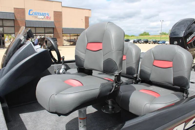 Slide: The Image of 2025 Tracker Pro Team 175 Crappie Edition boat seats with red accents, parked near Colman's RV. - 10