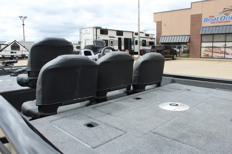 Slide: The Image of 2025 Tracker Pro Team 175 Crappie Edition boat with seating and storage, parked near dealership. - 11