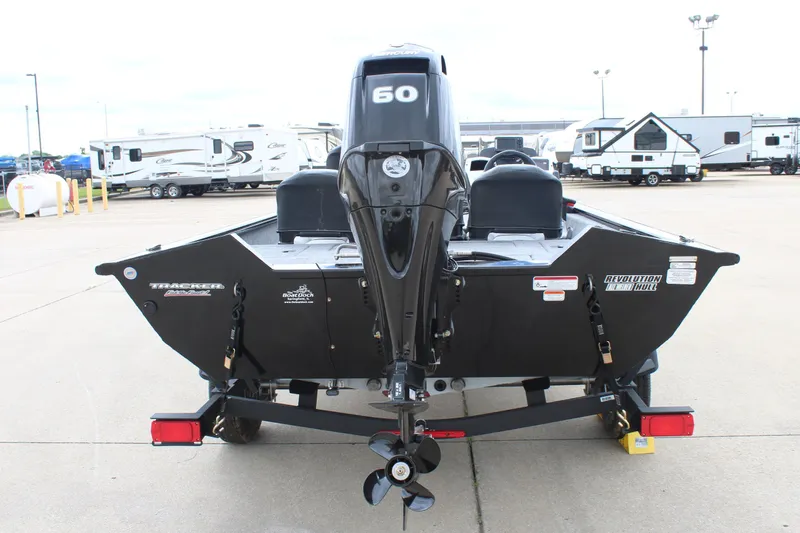 Slide: The Image of 2025 Tracker Pro Team 175 Crappie Edition boat with 50 HP engine, parked on trailer. - 2