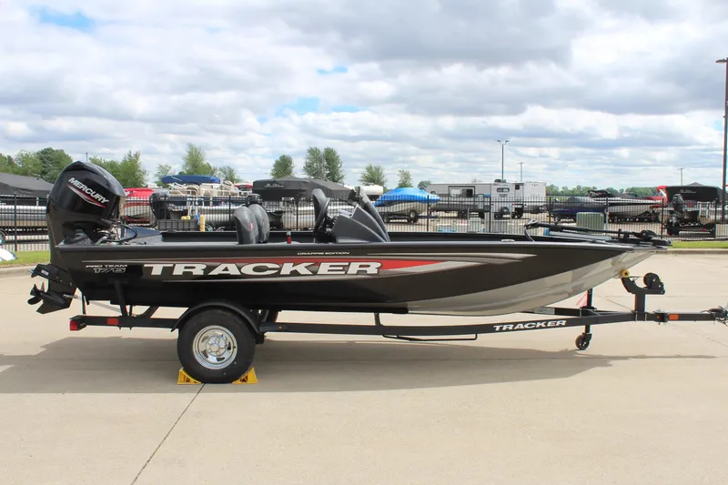Slide: The Image of 2025 Tracker Pro Team 175 Crappie Edition boat on trailer, parked outdoors. - 4