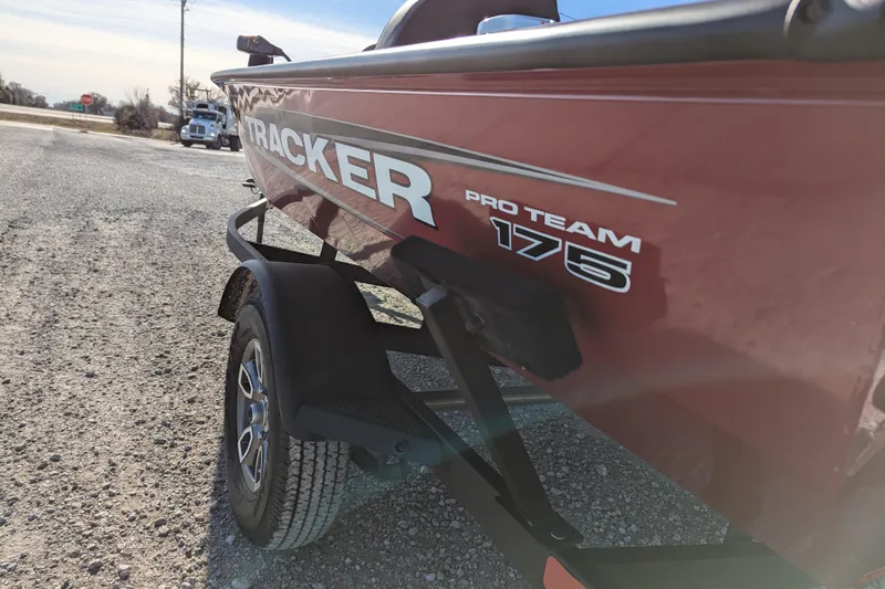 Slide: The Image of 2025 Tracker Pro Team 175 boat on trailer, side view in outdoor setting. - 62