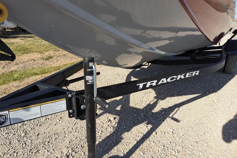 Slide: The Image of 2025 Tracker Pro Team 175 boat trailer on gravel surface. - 69