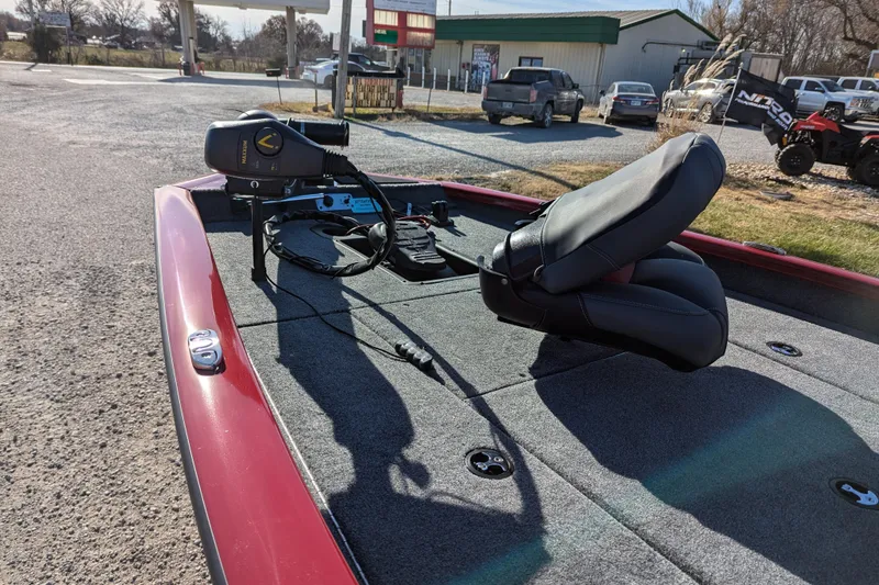 Slide: The Image of 2025 Tracker Pro Team 175 boat with trolling motor and seating, parked outdoors. - 70
