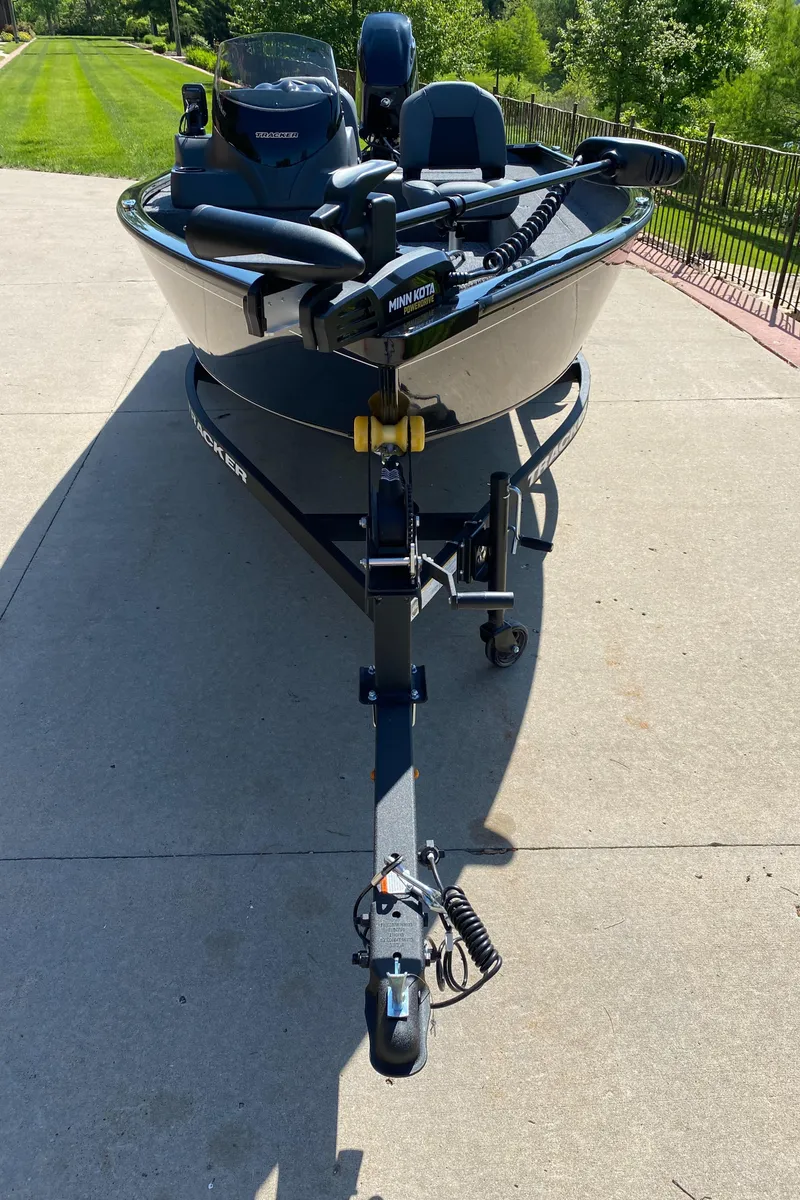 Slide: The Image of 2025 Tracker Super Guide V-16 SC boat on a driveway, front view. - 2