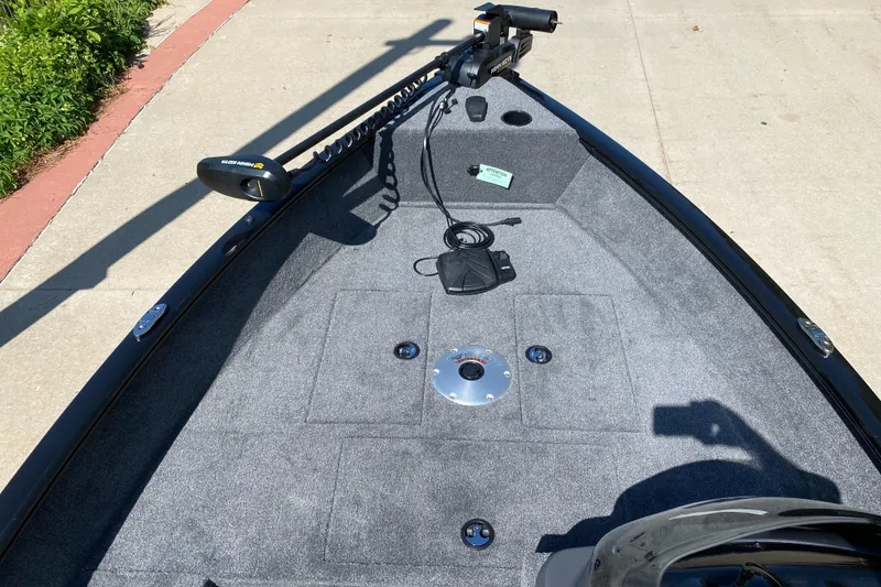 Slide: The Image of 2025 Tracker Super Guide V-16 SC boat deck with trolling motor and carpeted surface. - 3