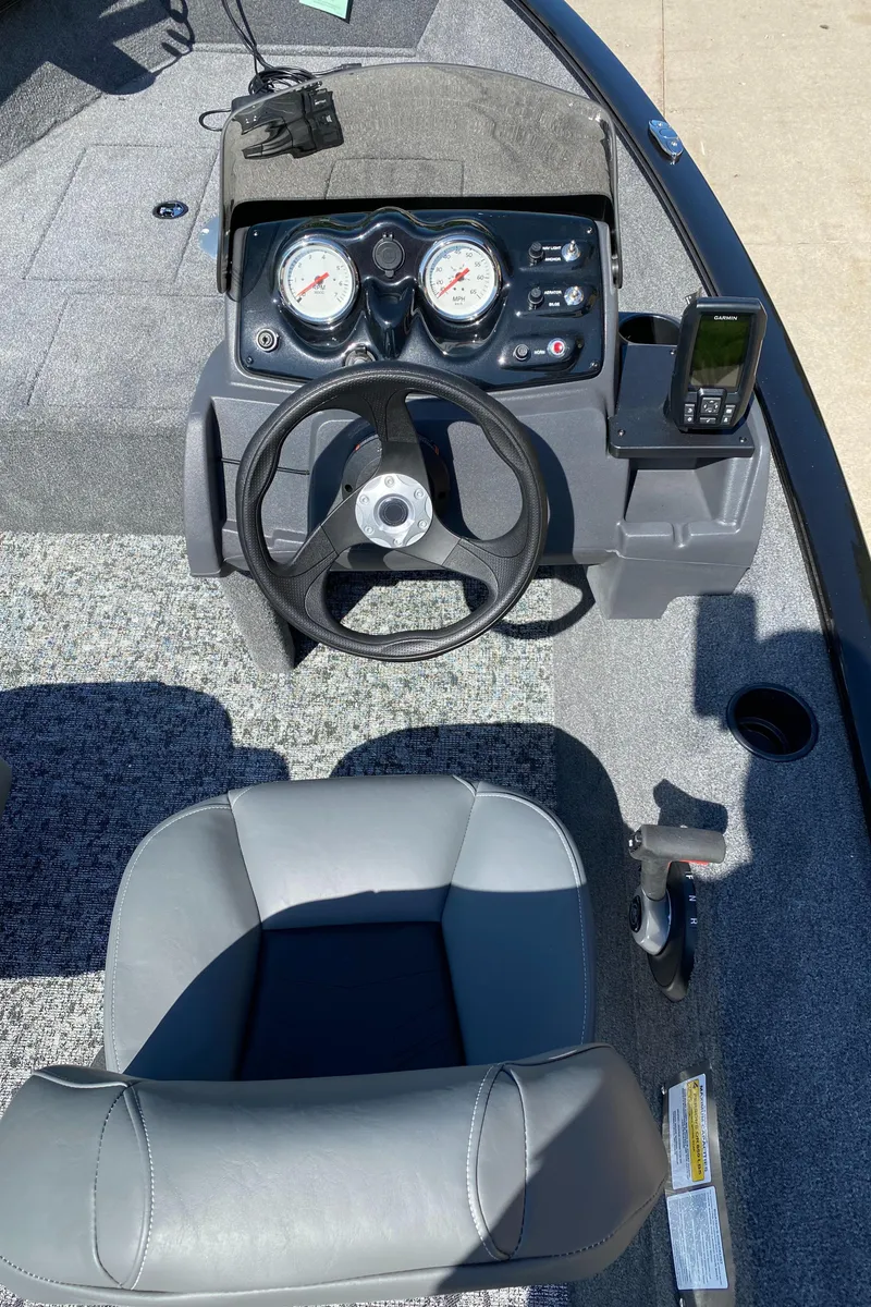 Slide: The Image of 2025 Tracker Super Guide V-16 SC boat dashboard with steering wheel and gauges. - 5