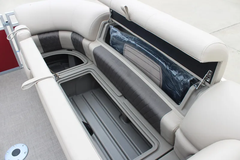 Slide: The Image of 2025 Sun Tracker Party Barge 22 DLX interior storage compartment with cushioned seating. - 11