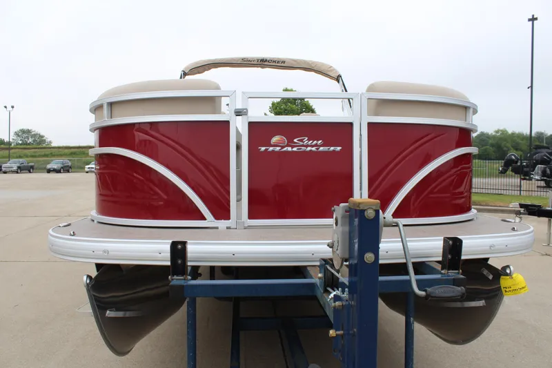 Slide: The Image of 2025 Sun Tracker Party Barge 22 DLX pontoon boat on trailer, red exterior. - 6